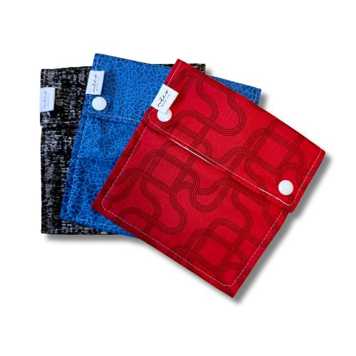 black blue and red three fabric bags with snaps