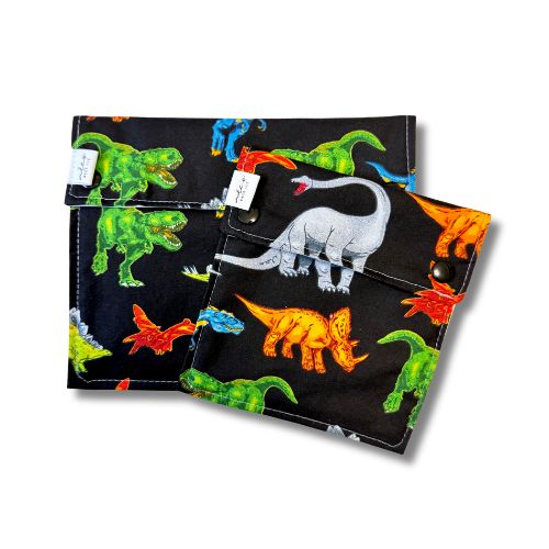 Two teal reusable bags with a dinosaur pattern on a white background