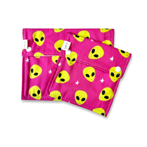 Pink snack bags with yellow alien patterns on a white background