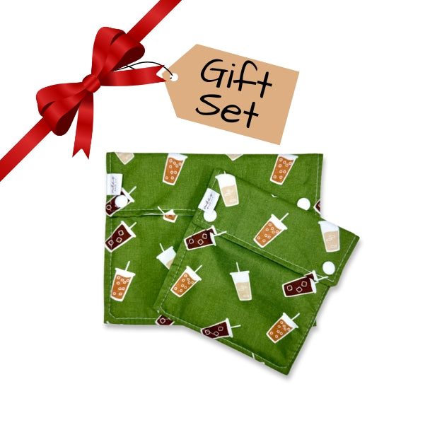 Green fabric snack bags with drink pattern and red ribbon on a white background