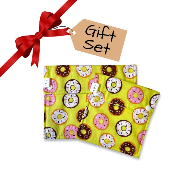 Gift set with a yellow fabric snack bags featuring donuts pattern and a red ribbon on a white background.