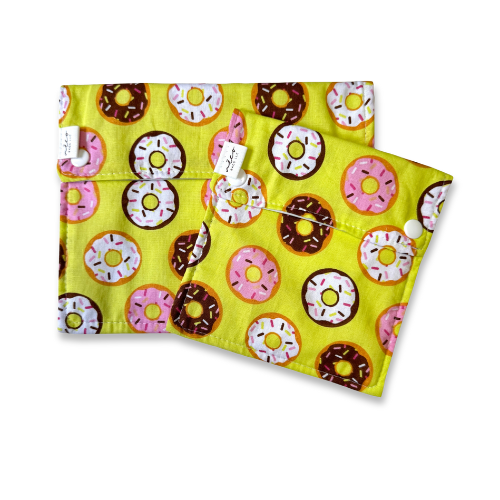 Two fabric snack bags with donuts pattern on a yellow background
