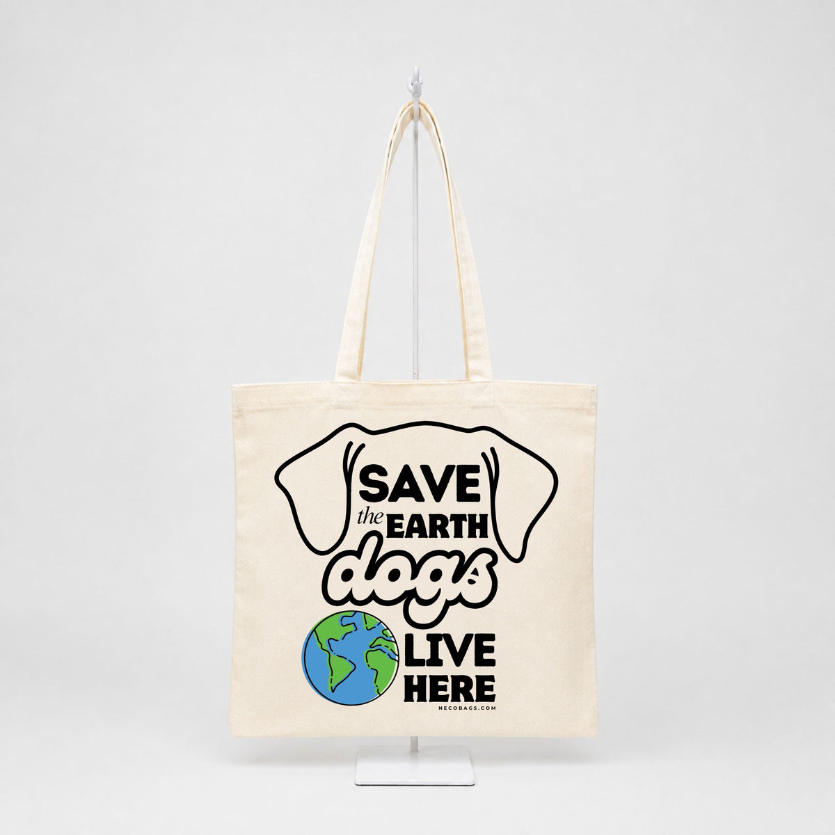 Natural cotton canvas tote bag with Save the Earth Dogs Live Here dog lover graphic featuring dog ears and a colorful Earth