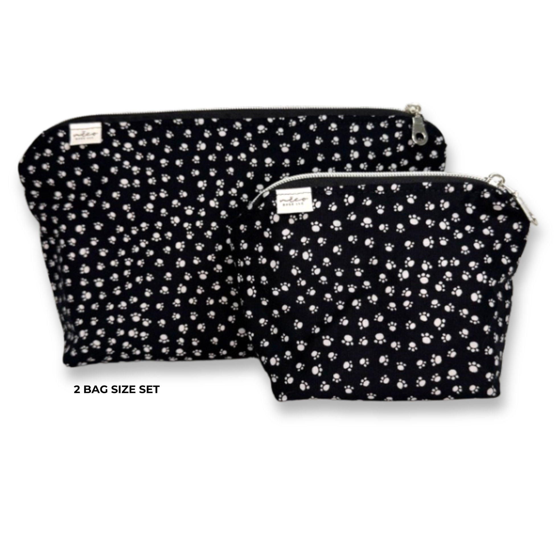 Two black zippered cosmetic pouches with a white paw print pattern, shown as a 2 bag size set on a white background. Machine Washable Cosmetic Bags
