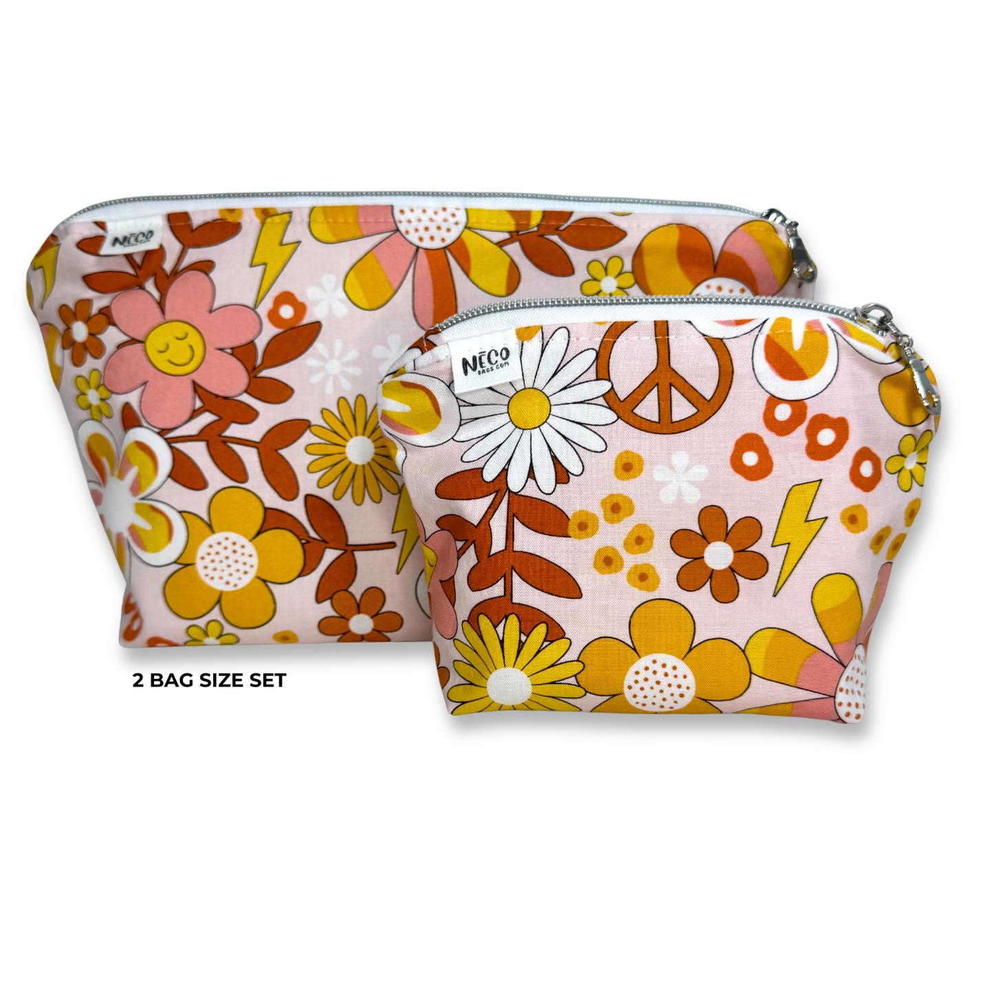Two zippered pouches in a retro 70s floral print set against a plain white background. The set includes a larger pouch and a smaller pouch, both featuring a pink base with yellow, orange, and brown flowers, daisies, peace signs, and lightning bolts. Machine Washable Cosmetic Bags 