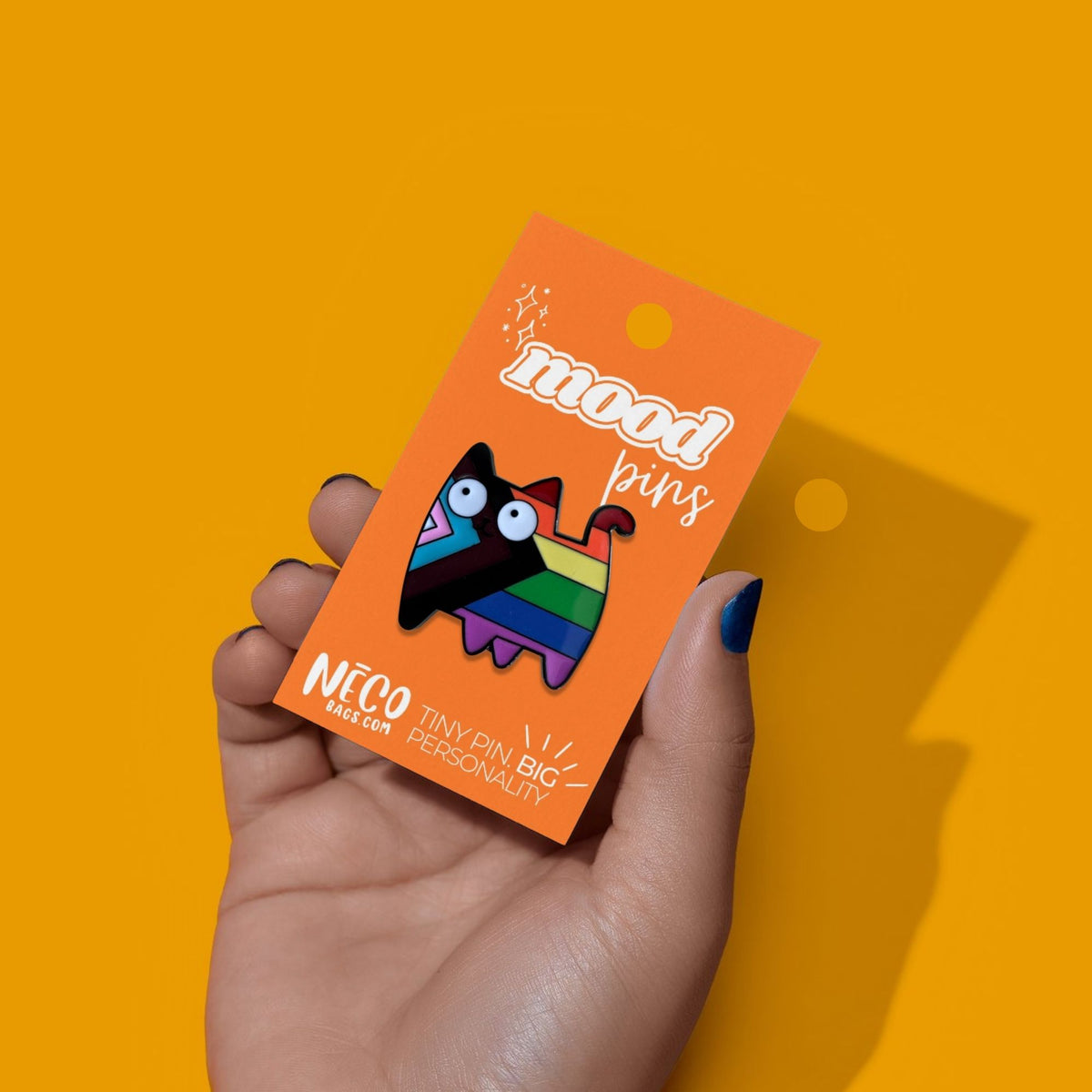 Colorful Pride cat enamel pin with Progress Pride-inspired rainbow stripes from the NECO Current Mood Pin Collection on display card