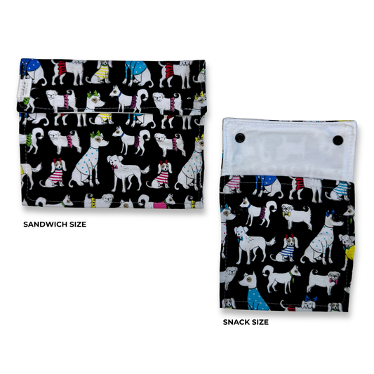 Two snack and sandwich bags  shown on a white background, labeled Sandwich Size and Snack Size. The pouches have a black background with a colorful cartoon dog print. Cute fun, and colorful machine washable food bags