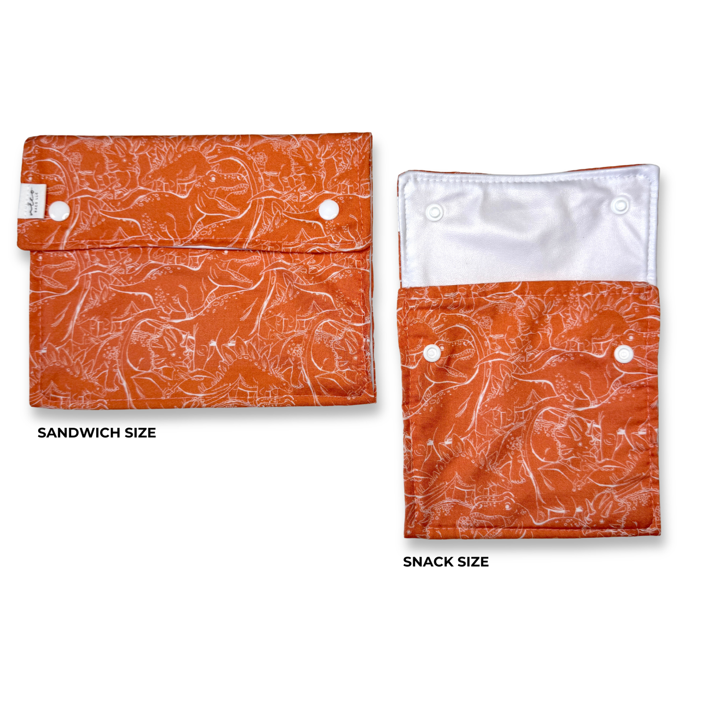 Two orange patterned snack pouches shown on a white background, labeled Sandwich Size and Snack Size. The pouches have a white abstract marbled pattern, snap closures, and a white food safe inner lining. Machine washable snack and sandwich bags