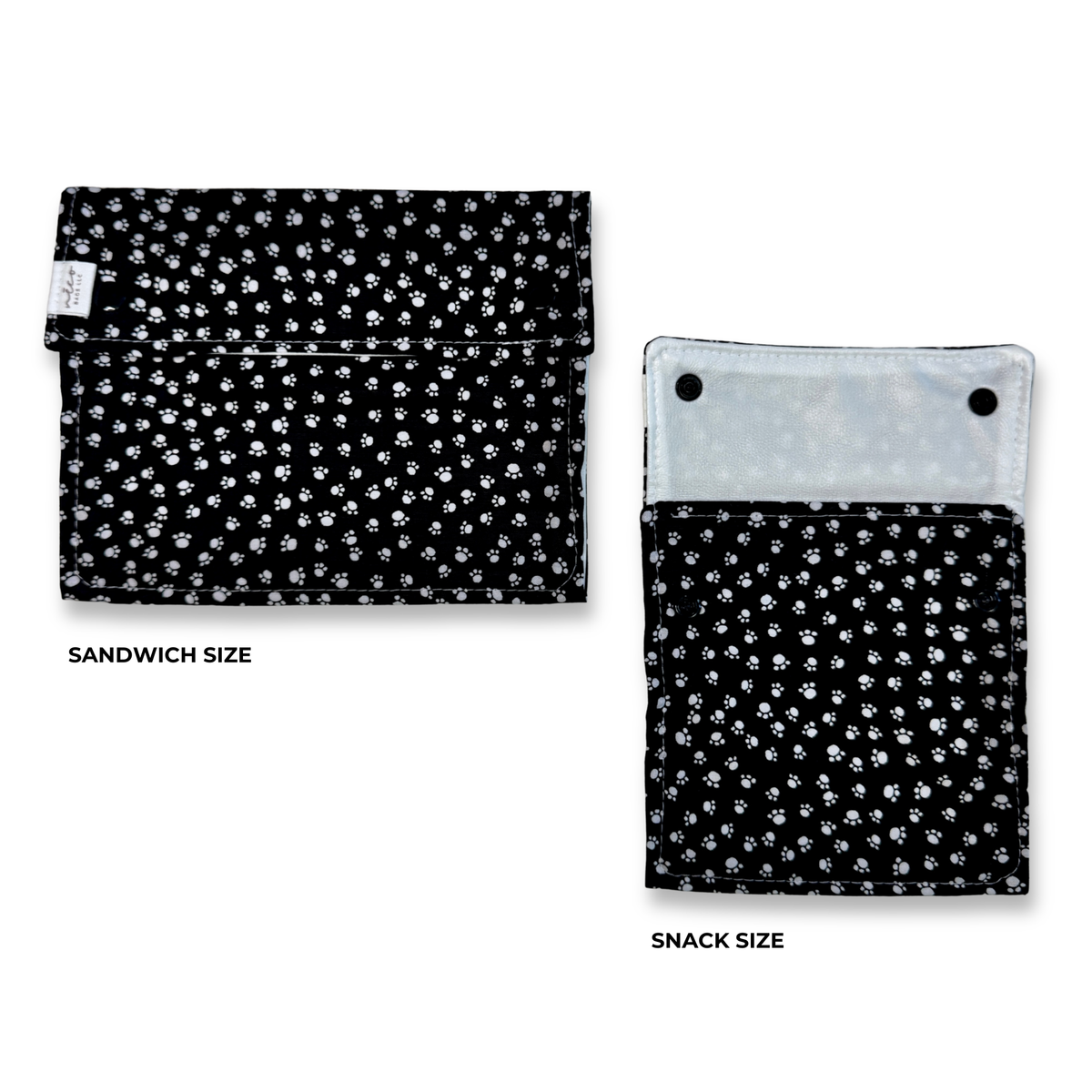 two reusable machine washable snack and sandwich bags. Black background with small white paw prints. 