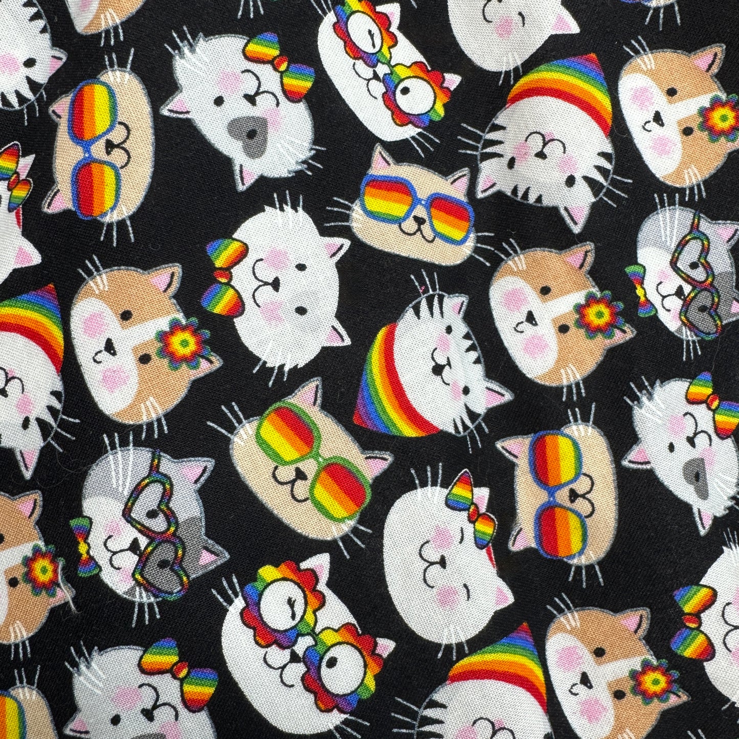 Pattern of cartoon animals with rainbow accessories on a black background