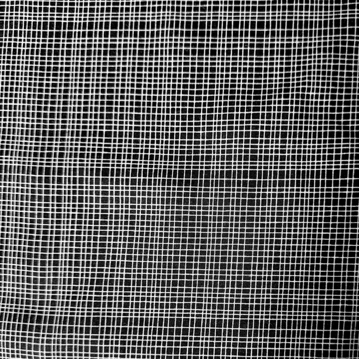A close-up of a black mesh fabric with a white grid pattern, filling the entire frame.