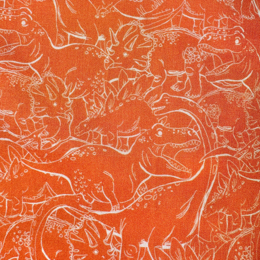 Orange fabric with a white line-art pattern of dinosaurs and prehistoric animals filling the frame.
