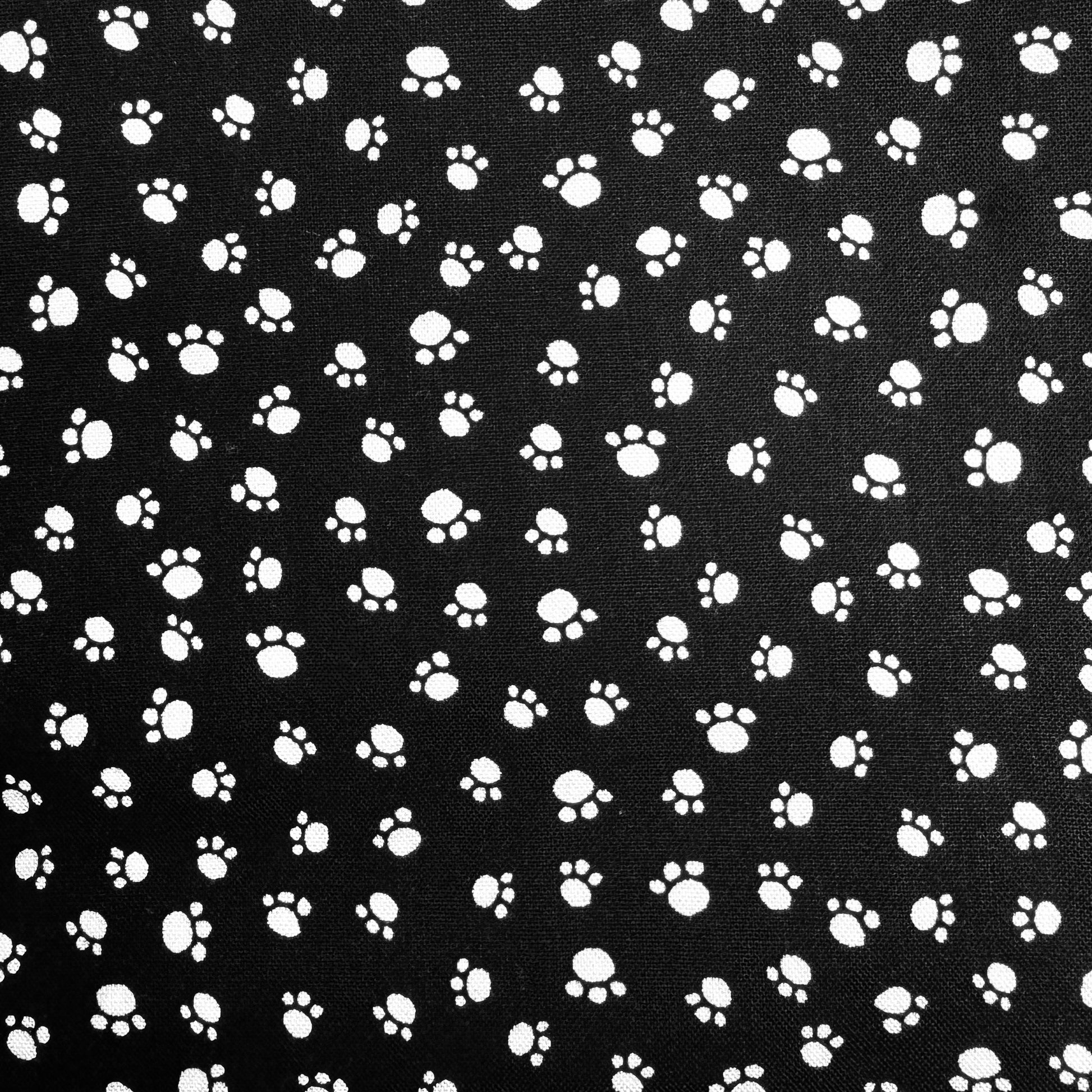 Pattern of white paw prints on a black background