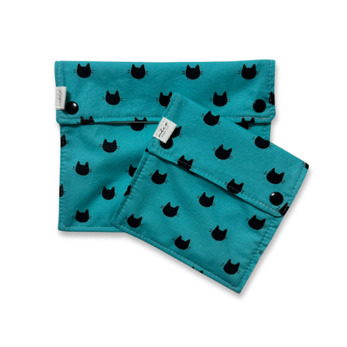 Teal fabric food bags with black cat patterns on a white background