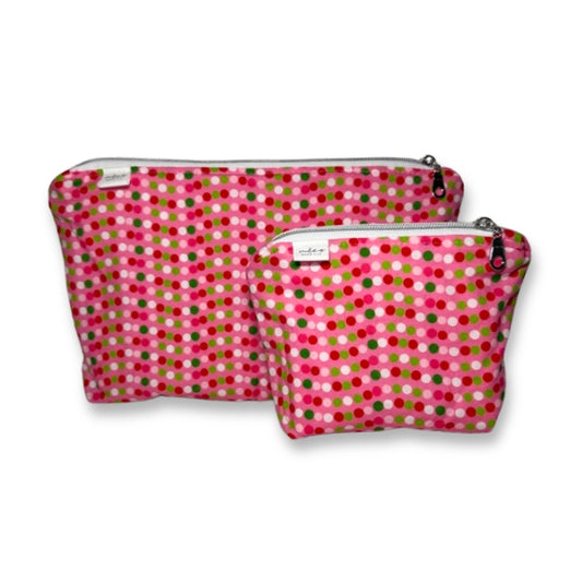 Two pink polka dot pouches on a white background