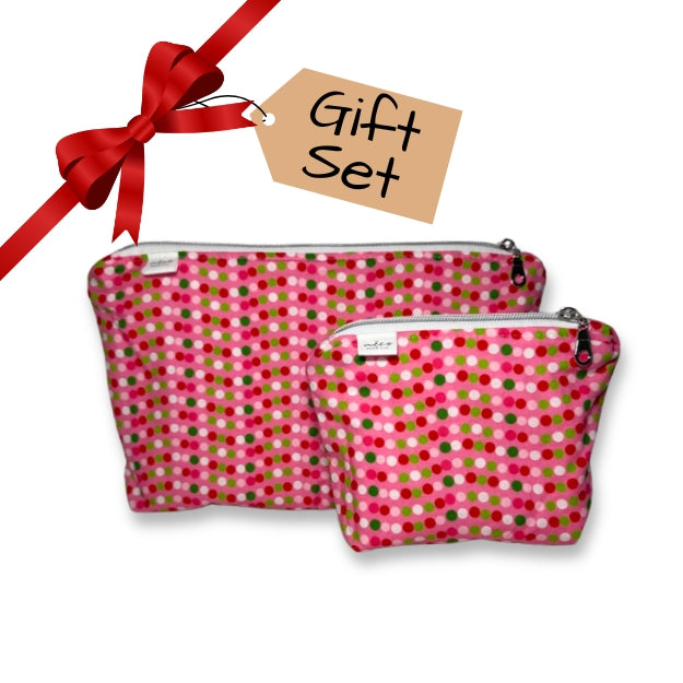 Two pink polka dot pouches with a red ribbon and 'Gift Set' tag on a white background