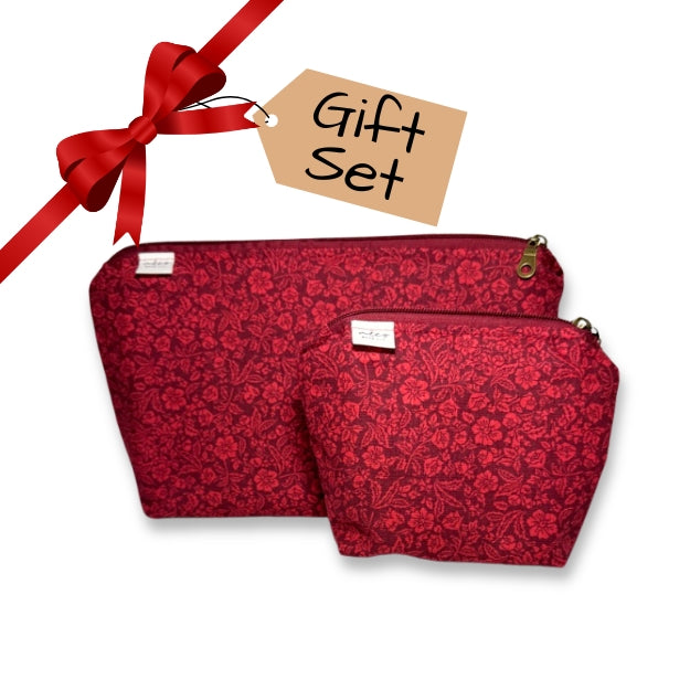 Two red floral-patterned pouches with a red ribbon and 'Gift Set' tag on a white background
