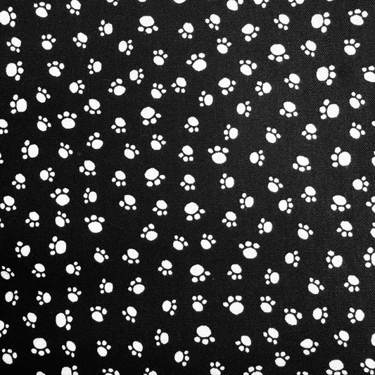 Pattern of white paw prints on a black background